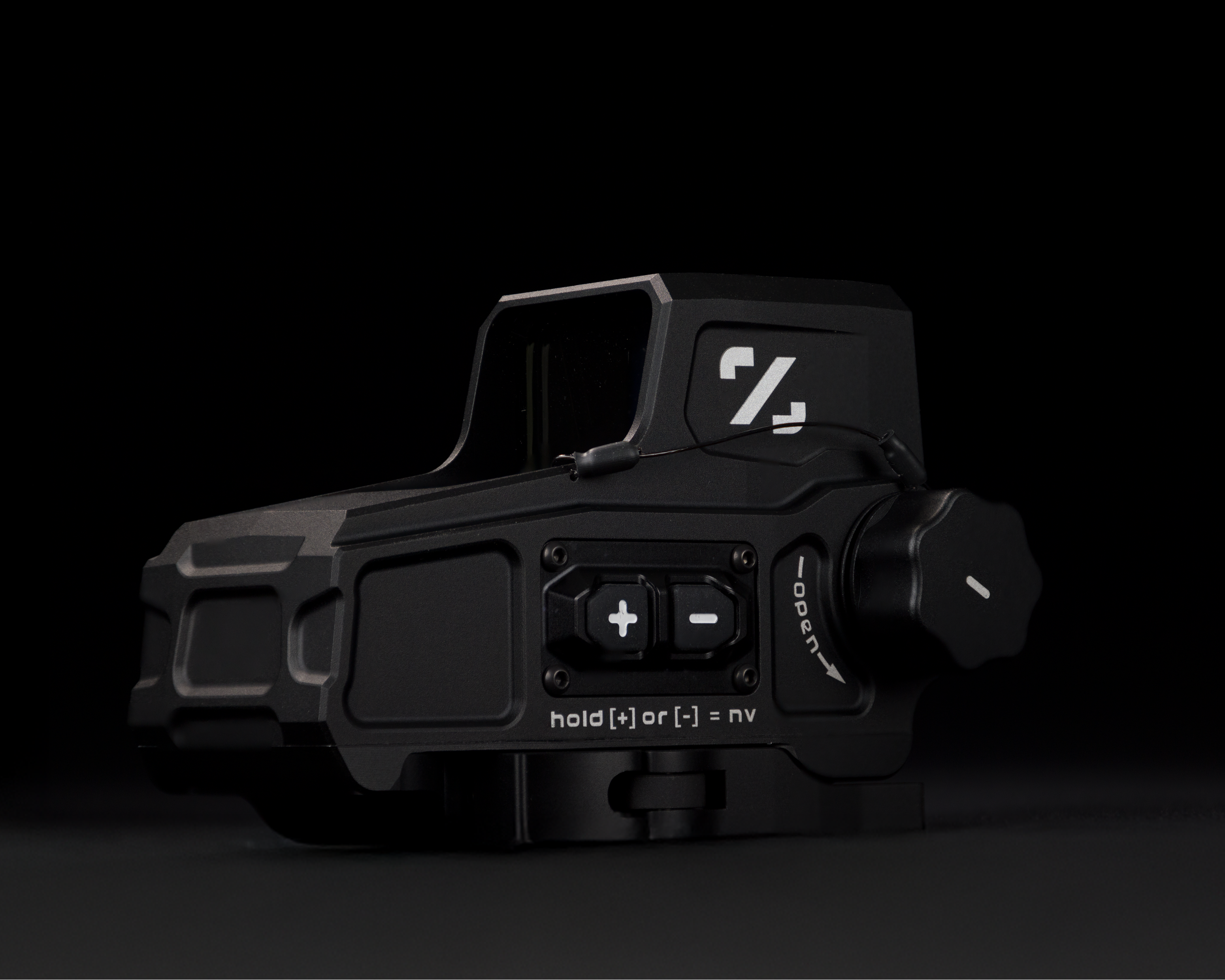 Black tactical device with visible branding on a black background